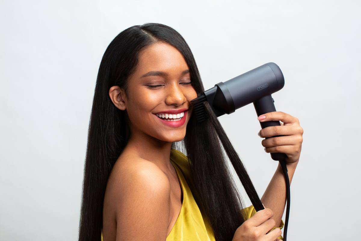 Close-up of healthy, glossy mid-length hair strands undergoing hair recovery therapy with a silk-wrapped treatment cap